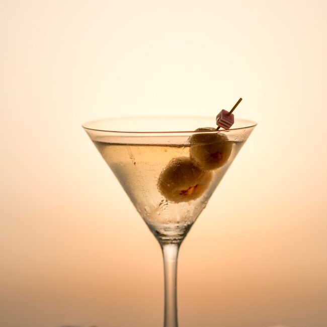 clear cocktail glass with yellow liquid